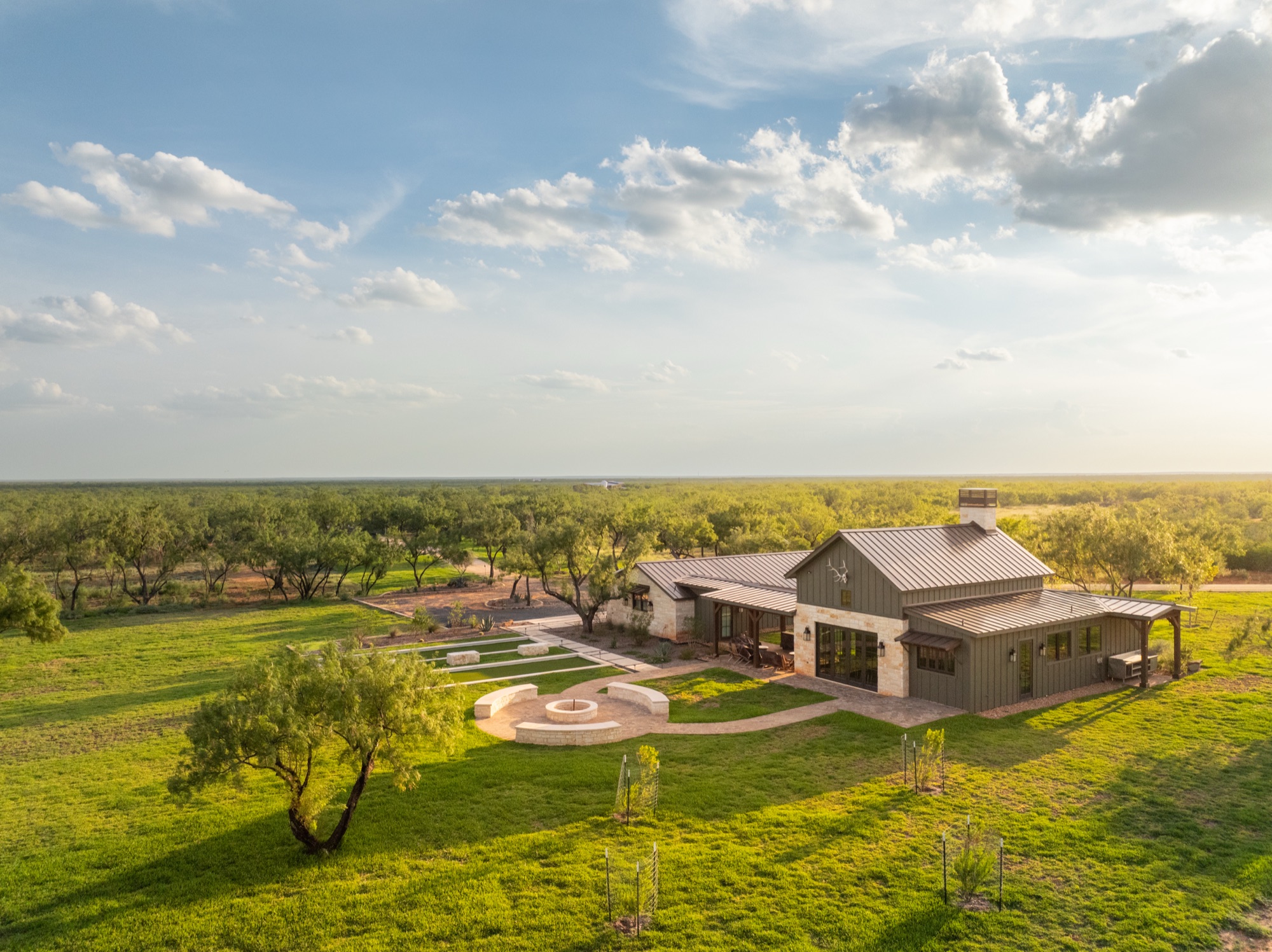 Aerial view of the main house at Big Wells Ranch at golden hour